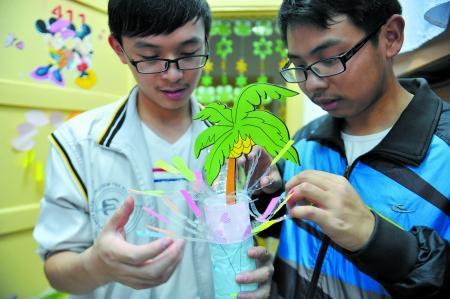 男生正把废旧物做成装饰品，装扮女生寝室。